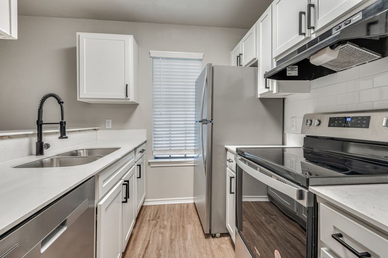 Renovated two-bedroom kitchen with quartz countertops